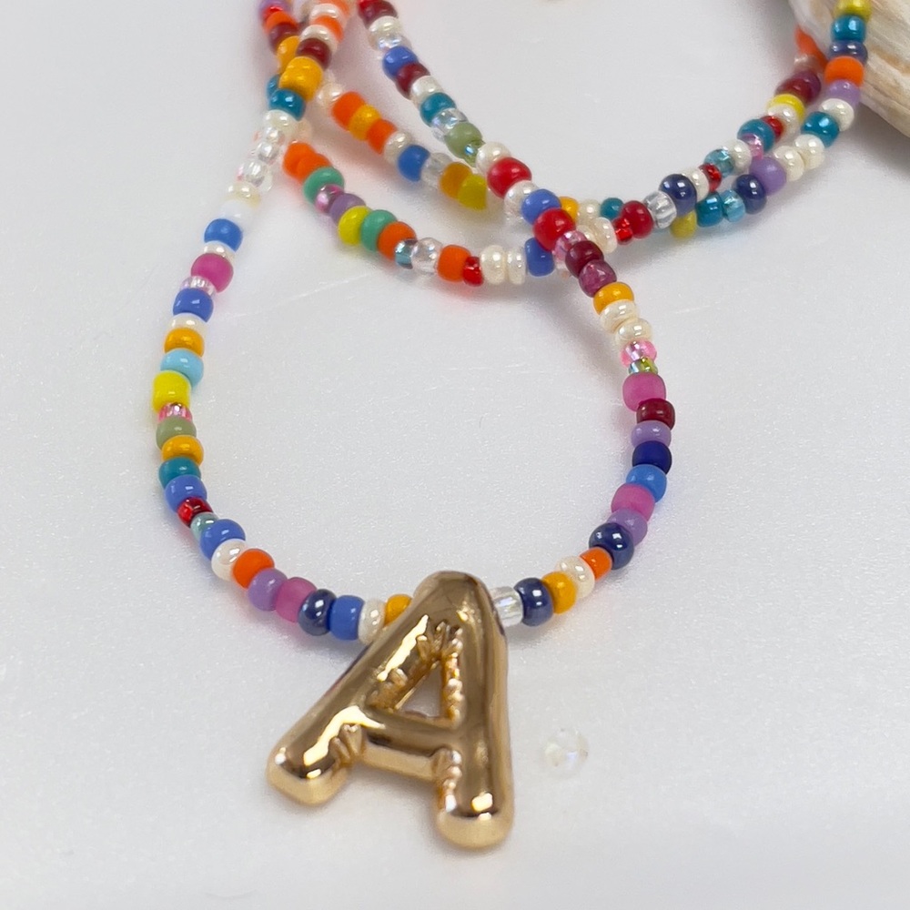 Colorful Beaded Necklace with Gold Letters Pendant